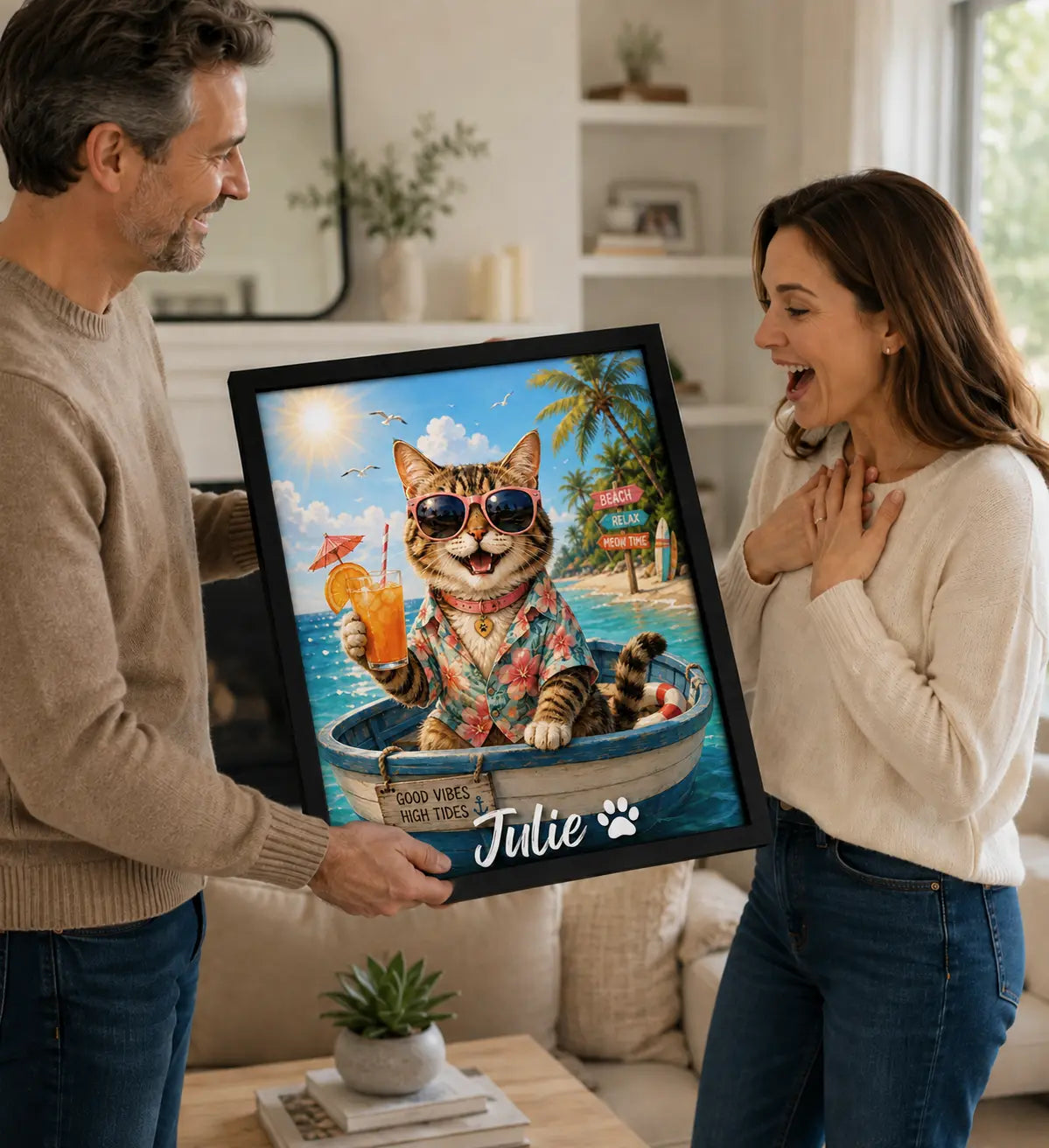 Couple holding a framed tropical portrait of Julie the cat